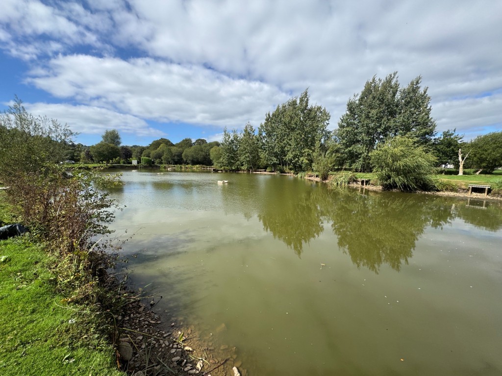 Lot: 71 - FREEHOLD TEN ACRE SITE WITH LAKES AND LODGES - Main Lake - view 1